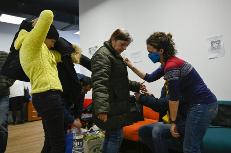 A volunteer helps Ukrainian refugees to choose clothes in a situation centre in Sofia, Bulgaria for people affected by the war