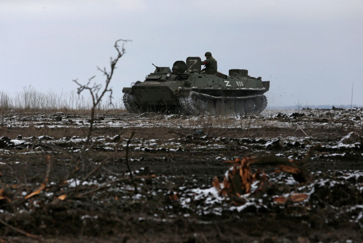 Service members of pro-Russian troops in uniforms without insignia drive an armoured vehicle with the letters "Z" painted on it in the separatist-controlled town of Volnovakha during Ukraine-Russia conflict in the Donetsk region, Ukraine March 11, 2022. 