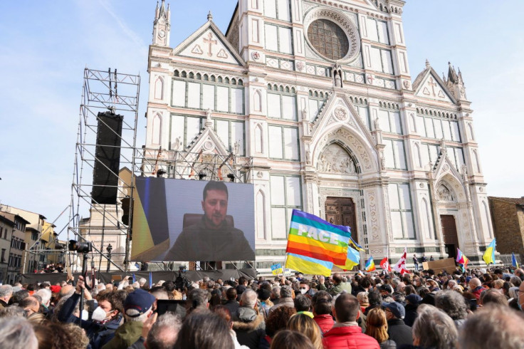 Ukrainian President Volodymyr Zelenskiy addresses demonstrators via video as they gather in Santa Croce square to protest against the Russian invasion of Ukraine, in Florence, Italy, March 12, 2022. 