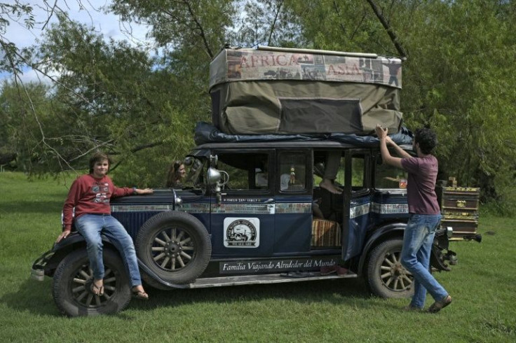 Members of the Zapp family of Argentina open up a canvas that acts as a tent atop their 1928 Graham-Paige car near Gualeguaychu, Argentina, on March 10