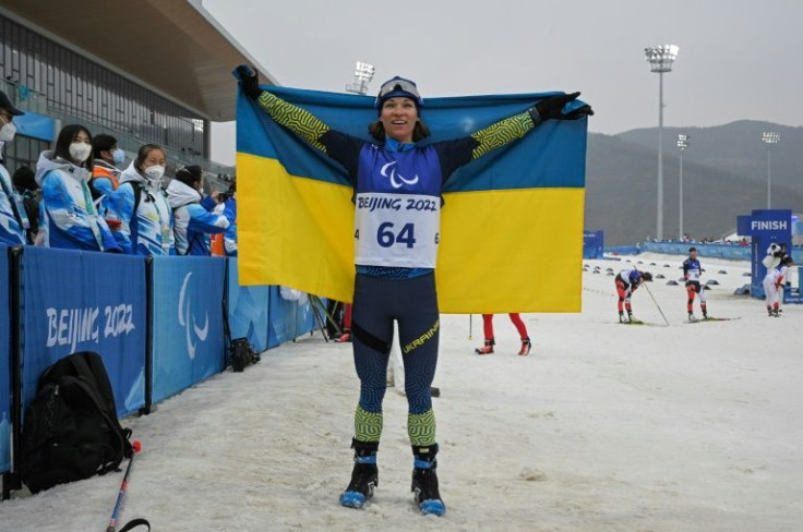 Ukraine's Liudmyla Liashenko celebrates after winning the women's individual standing para biathlon final event on March 11, 2022, at the Zhangjiakou National Biathlon Centre during the Beijing 2022 Winter Paralympic Games.