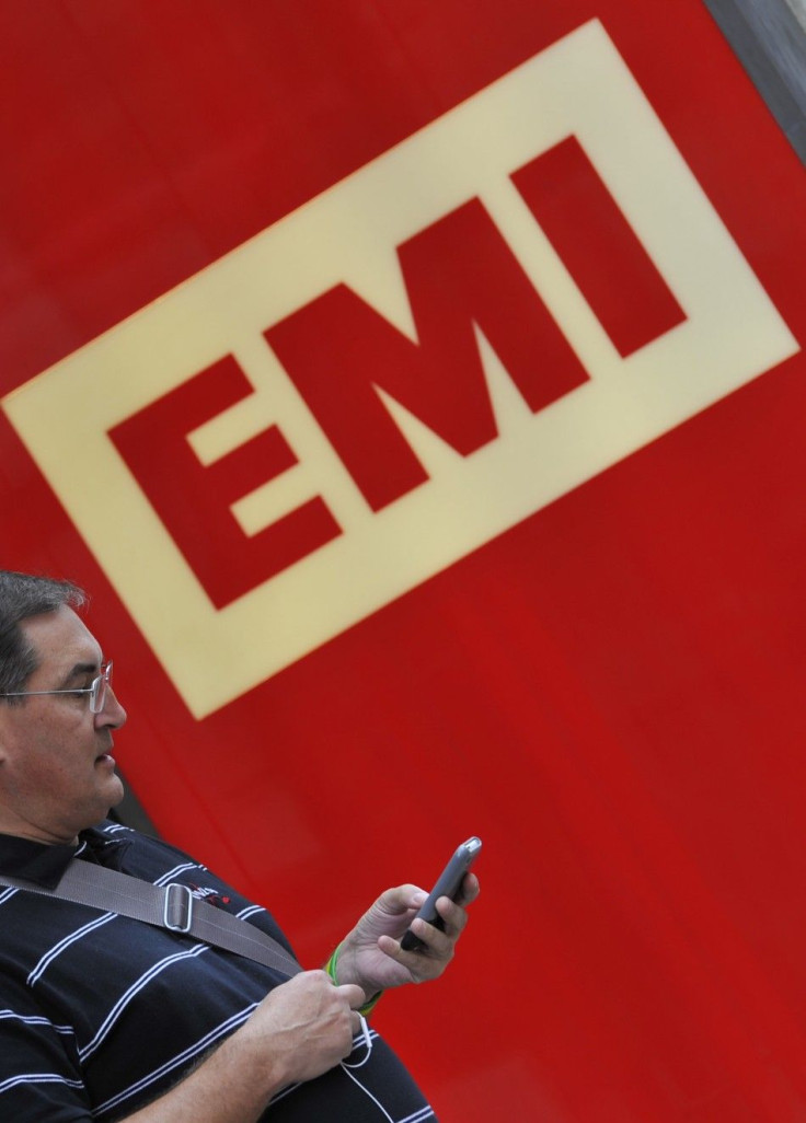 A man uses his phone outside EMI offices in west London