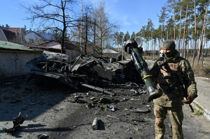 A Ukrainian soldier holds an anti-tank weapon that was used to destroy a Russian armoured personal carrier in Irpin, north of Kyiv, on March 12, 2022