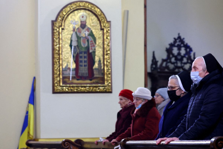 Members of the archcathedral of St. John the Baptist church community attend the church service, near the Polish-Ukrainian border as people flee the Russian invasion of Ukraine, in Przemysl, Poland, March 13, 2022.   