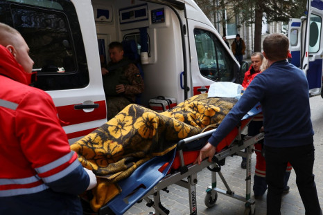Medics transport a serviceman on a stretcher, following an attack on the Yavoriv military base, amid Russia's invasion of Ukraine, at a hospital in Yavoriv, Ukraine, March 13, 2022. 