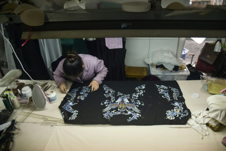 A tailor makes a qipao at a studio in Shanghai