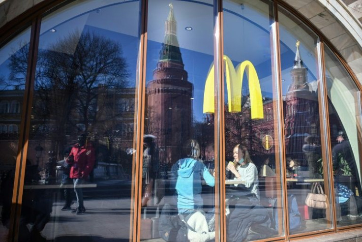 People have a lunch a McDonald's restaurant next to the Kremlin in Moscow on March 10