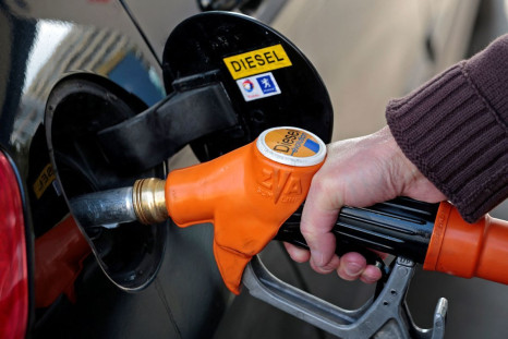 A customer fills-up his car with diesel at a gas station in Nice March 4, 2013. 