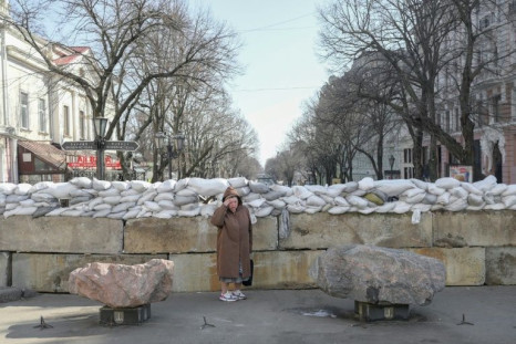 A resident stands next to a sandbag barricade in Odessa on March 13, 2022