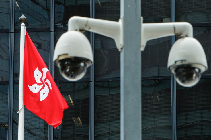 A Hong Kong flag is flown behind a pair of surveillance cameras outside the Central Government Offices in Hong Kong, China July 20, 2020.