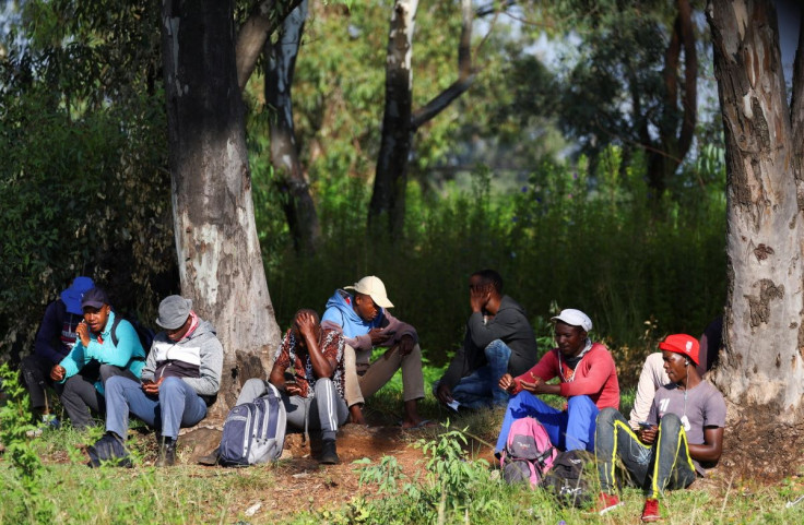 Job seekers wait beside a road for casual work offered by passing motorists in Eikenhof, south of Johannesburg, South Africa, March 3, 2022. Picture taken March 3, 2022.