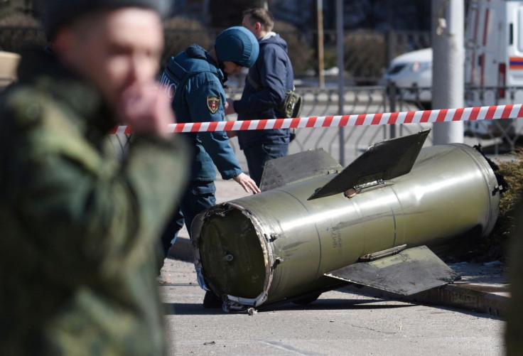 A member of the Emergencies Ministry of the separatist Donetsk People's Republic inspects the remains of a missile that landed in the street in the separatist-controlled city of Donetsk, Ukraine March 14, 2022. 