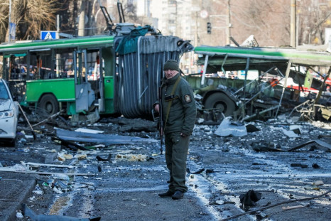 A police officer guards an area around a building destroyed by shelling as Russia's attack on Ukraine continues, in Kyiv, Ukraine March 14, 2022. 