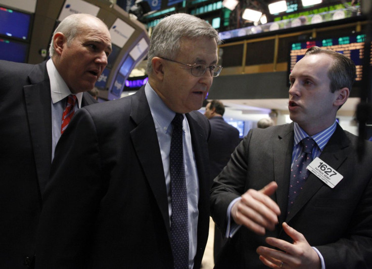 LyondellBasell Industries CEO, Jim Gallogly (C) talks with Barclay's Capital trader Patrick Kenny on the floor of the New York Stock Exchange, May 2, 2011.