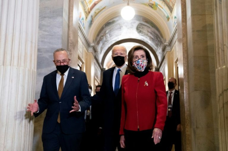 US House Speaker Nancy Pelosi (right) and Senate Majority Leader Chuck Schumer are among congressional leaders from both parties who have bee pushing for a tough line on Russia from President Joe Biden (center)