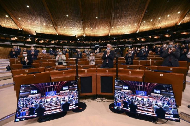 Members of the political delegations of the Parliamentary Assembly of the  the Council of Europe applaud after a minute of silence for the victims of the Russian invasion of Ukraine on March 14, 2022 at the Council of Europe in Strasbourg, northeastern Fr