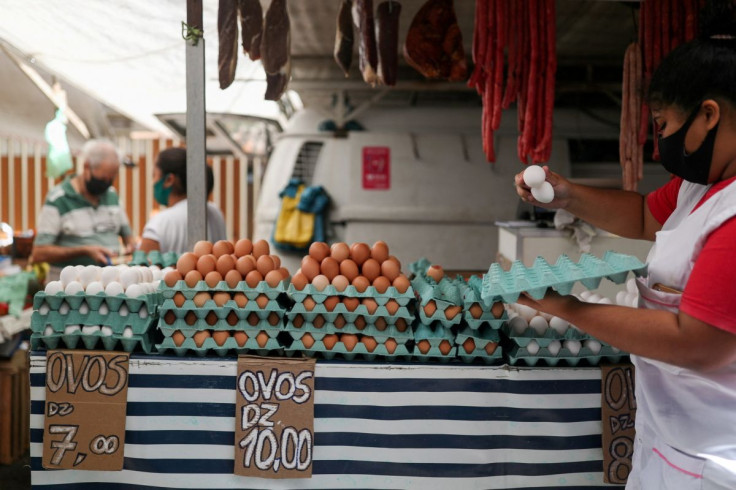 A vendor holds eggs at a weekly street market in Rio de Janeiro, Brazil July 8, 2021. 