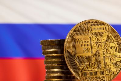 A representation of the cryptocurrency is seen in front of Russian flag in this illustration taken, March 4, 2022. 
