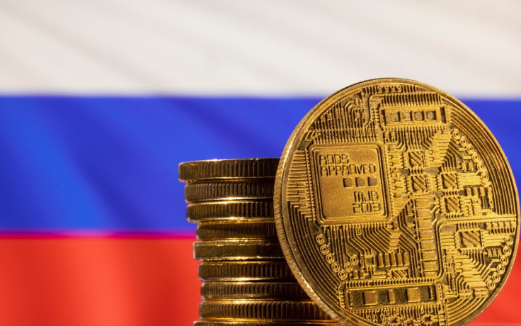 A representation of the cryptocurrency is seen in front of Russian flag in this illustration taken, March 4, 2022. 