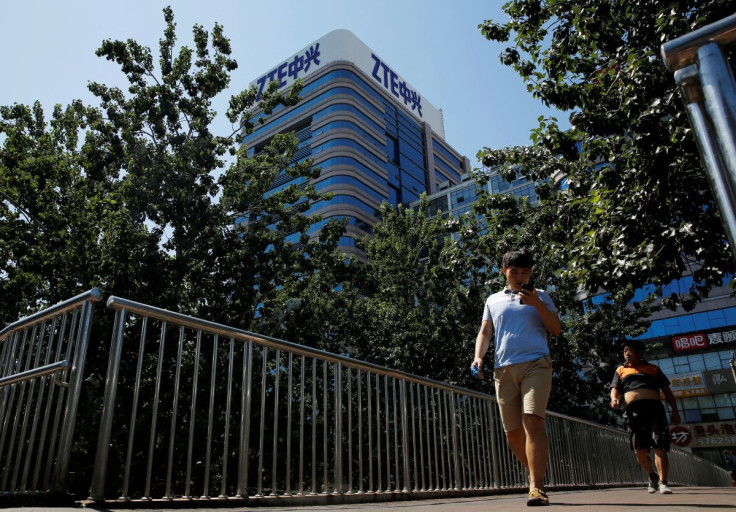 People walk past a building of China's ZTE Corp in Beijing, China, August 29, 2018.  