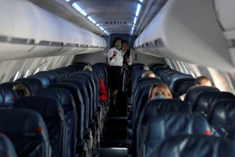Flight attendants talk on a Delta Airlines flight operated by SkyWest Airlines during a flight departing from Salt Lake City, Utah, U.S. April 11, 2020. 