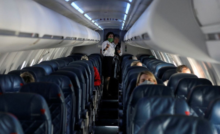 Flight attendants talk on a Delta Airlines flight operated by SkyWest Airlines during a flight departing from Salt Lake City, Utah, U.S. April 11, 2020. 