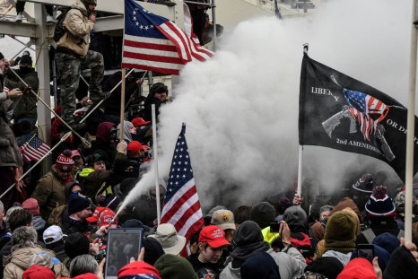 A supporter of U.S. President Donald Trump sprays smoke during a "Stop the Steal" protest outside of the Capitol building in Washington D.C. U.S. January 6, 2021. 