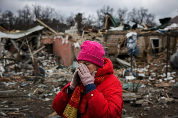 Irina Moprezova, 54, reacts in front of a house that was damaged in an bombing by Russian aircraft in Irpin, northwest of Kyiv