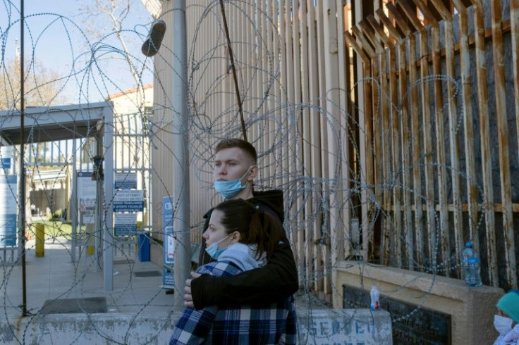 Ukrainians Sasha and Julia wait at the San Ysidro border crossing in Tijuana in northwestern Mexico hoping to enter the United States