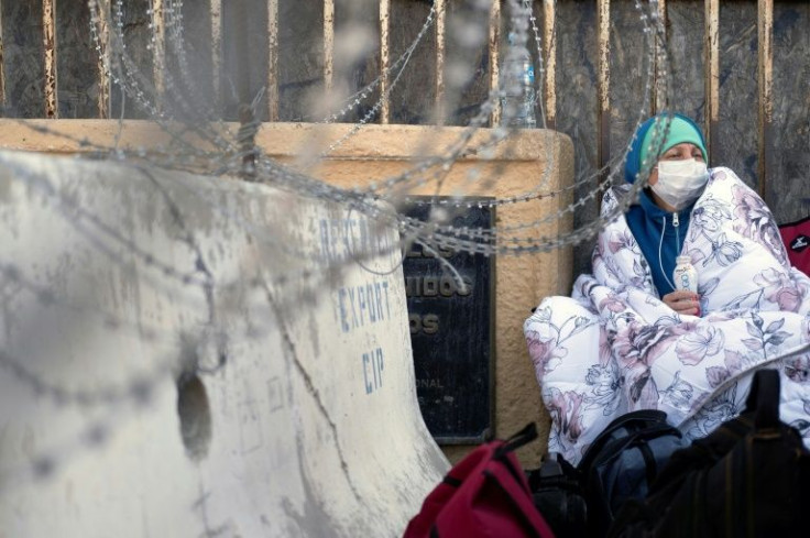 A Russian woman waits on the Mexican side of the San Ysidro border crossing in Tijuana to see if she will be allowed into the United States