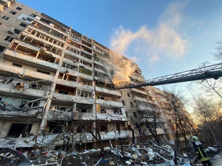 Rescuers work next to a residential building damaged by shelling, as Russia's attack on Ukraine continues, in Kyiv, Ukraine, in this handout picture released March 15, 2022.  Press service of the State Emergency Service of Ukraine/Handout via REUTERS 