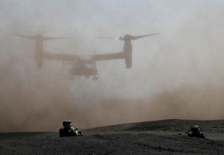 Members of the Japanese Self-Defense Forceâs Amphibious Rapid Deployment Brigade take positions while U.S. Marine Corps MV-22 Osprey lands during a joint airborne landing exercise with U.S. Marine Corps members at Higashifuji training field in Gotemba, 