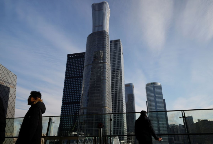 Men stand on a balcony overlooking the central business district in Beijing, China December 15, 2020.