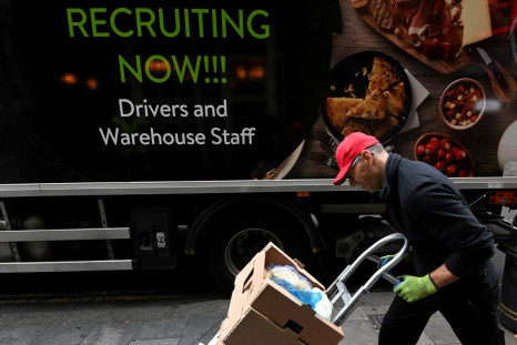 A lorry driver passes a sign on the side of his vehicle advertising for jobs as he makes a delivery, in London, Britain, October 13, 2021. 