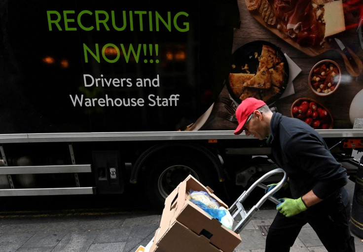 A lorry driver passes a sign on the side of his vehicle advertising for jobs as he makes a delivery, in London, Britain, October 13, 2021. 