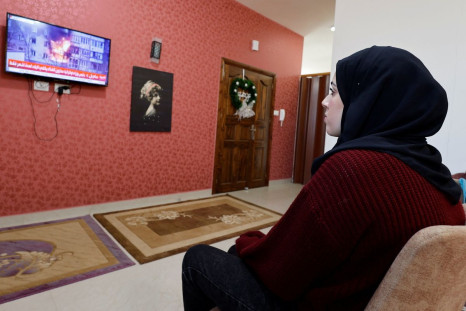 Palestinian university student Samar Aita, who studied in Ukraine, watches news about Ukraine's invasion by Russia at her house, in Rafah in the southern Gaza Strip, March 13, 2022. Picture taken March 13, 2022. 