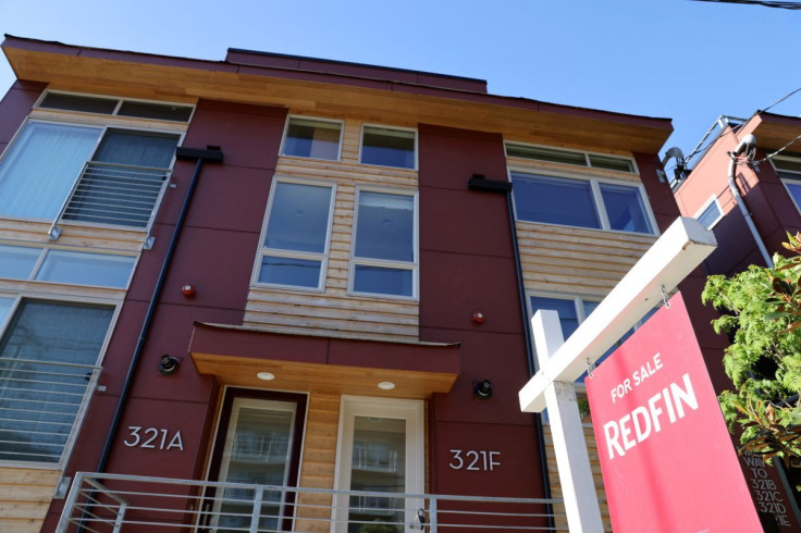 A "For Sale" sign is posted outside a residential home in the Queen Anne neighborhood of Seattle, Washington, U.S. May 14, 2021.   