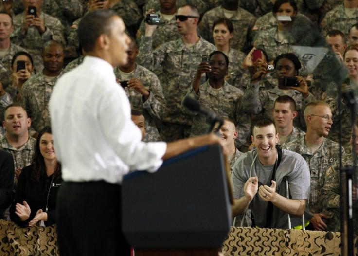 A soldier wounded in Afghanistan applauds as U.S. President Barack Obama speaks to troops at Fort Campbell in Kentucky May 6, 2011. Obama addressed several military units that have recently returned from duty in Afghanistan.