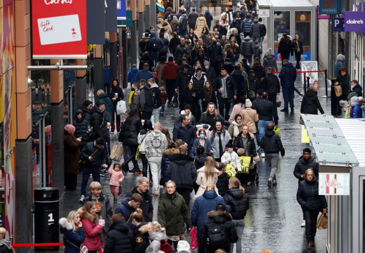 People walk along a busy shopping street as people look for bargains in the traditional Boxing Day sales in Liverpool, Britain, December 26 , 2021. 
