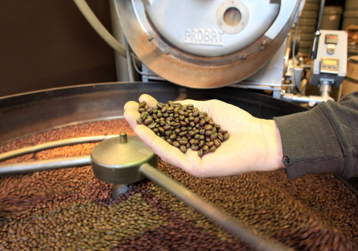 An employee checks freshly roasted coffee beans during cooling down in a tumbler at H. Schwarzenbach coffee roastery in Zurich, Switzerland December 4, 2018. 