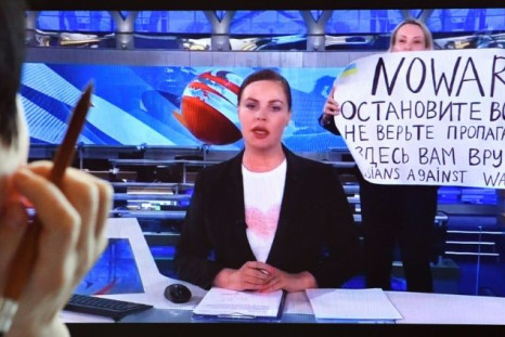 Marina Ovsyannikova, an editor at Channel One TV, barged onto the set of its flagship evening news broadcast holding a poster reading 'No War'