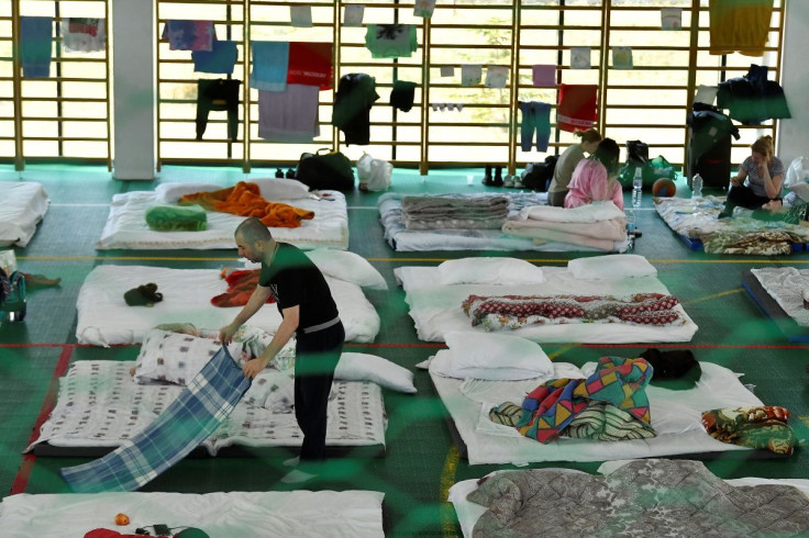 A man fixes his blanket at Dumbraveni sports arena which has been converted to a temporary shelter, after he fled Ukraine through a border crossing in Romania, following Russia's invasion of Ukraine, in Suceava, Romania March 15, 2022.