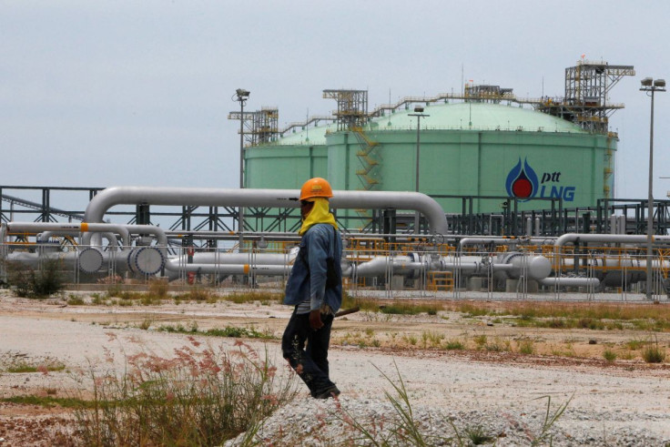 An employee of Thai energy giant PTT walks outside the company's Liquefied Natural Gas (LNG) terminal at the Map Ta Phut industrial estate in Rayong province, east of Bangkok September 7, 2011.