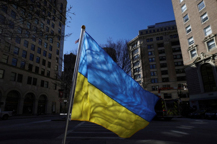A Ukrainian flag, a larger flag planted amid 500 smaller Ukrainian flags in a park, flies in downtown Boston, Massachusetts, U.S., March 14, 2022.   