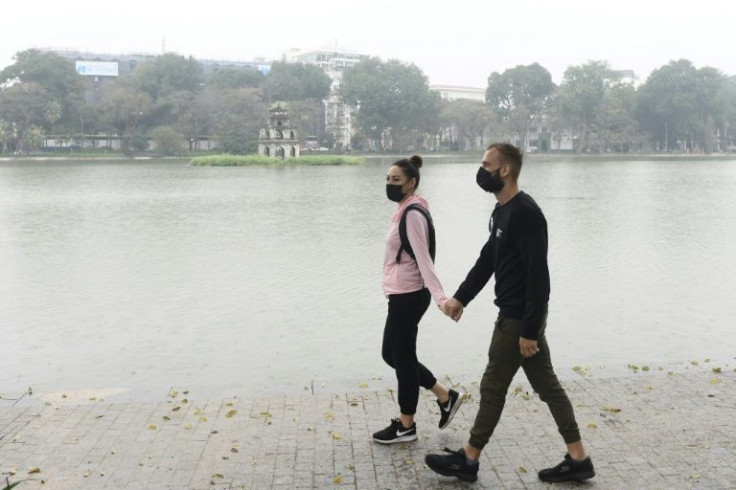 A couple from South Africa walk through downtown Hanoi. Vietnam's tourism sector was worth up to $32 billion a year before the pandemic