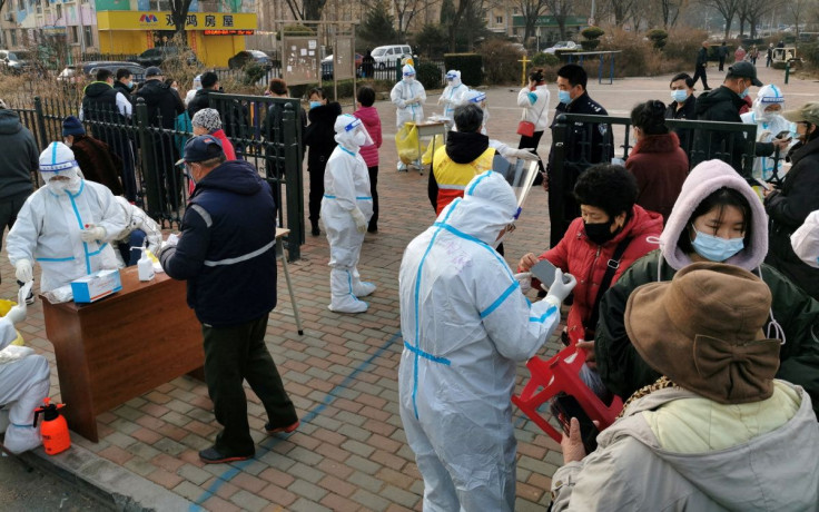 Residents line up at a nucleic acid testing site during a mass testing for the coronavirus disease (COVID-19), at a residential compound in Dalian, Liaoning province, China March 16, 2022. China Daily via REUTERS 