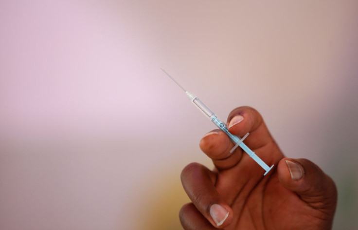 A health-worker holds a syringe before administering a booster shot vaccine against coronavirus disease (COVID-19), at a medical clinic makeshift tent to enhance the booster programme in Nairobi, Kenya, January 19, 2022.