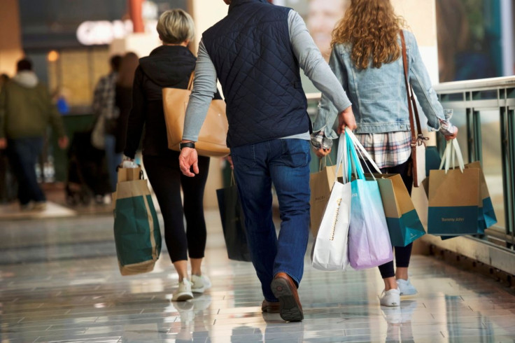 Shoppers carry bags of purchased merchandise at the King of Prussia Mall, United States' largest retail shopping space, in King of Prussia, Pennsylvania, U.S., December 8, 2018.  