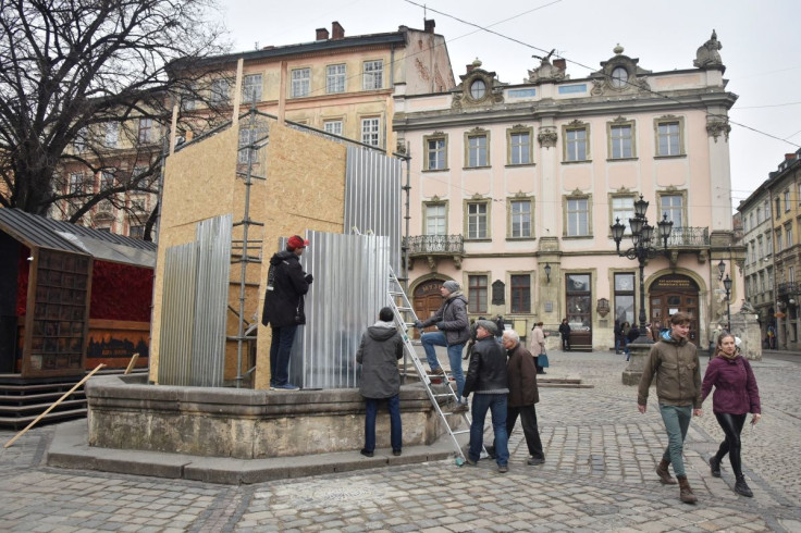 Workers strengthen a sculpture with special protection, as Russia's invasion of Ukraine continues, in Lviv, Ukraine, March 16, 2022.