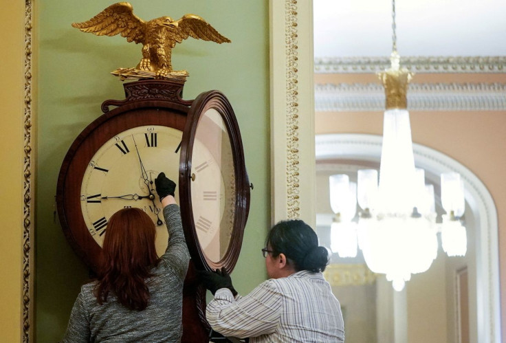 Employees with the Architect of the Capitol wind the Ohio Clock in the U.S. Capitol in Washington, U.S., January 21, 2020. 